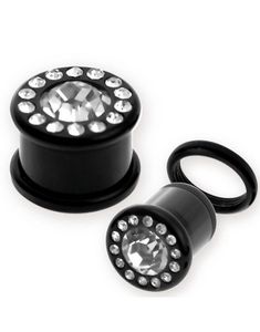 Svart Piercing Plugg med En Klar Sten Rammet inn med Små